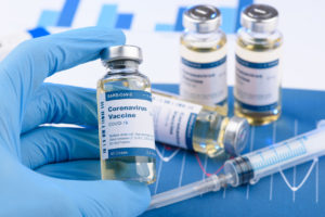 Coronavirus COVID-19 vaccine vial and injection syringe
