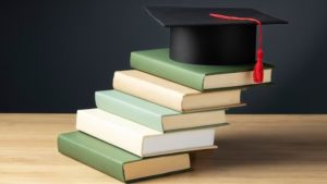 high-angle-of-books-and-a-graduation-cap-for-education-day_23-2149241020